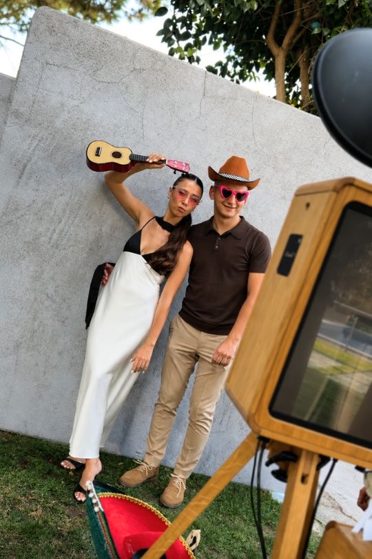 Los novios posando en el fotomatón con atrezzo divertido — boda en Mas de la Sala