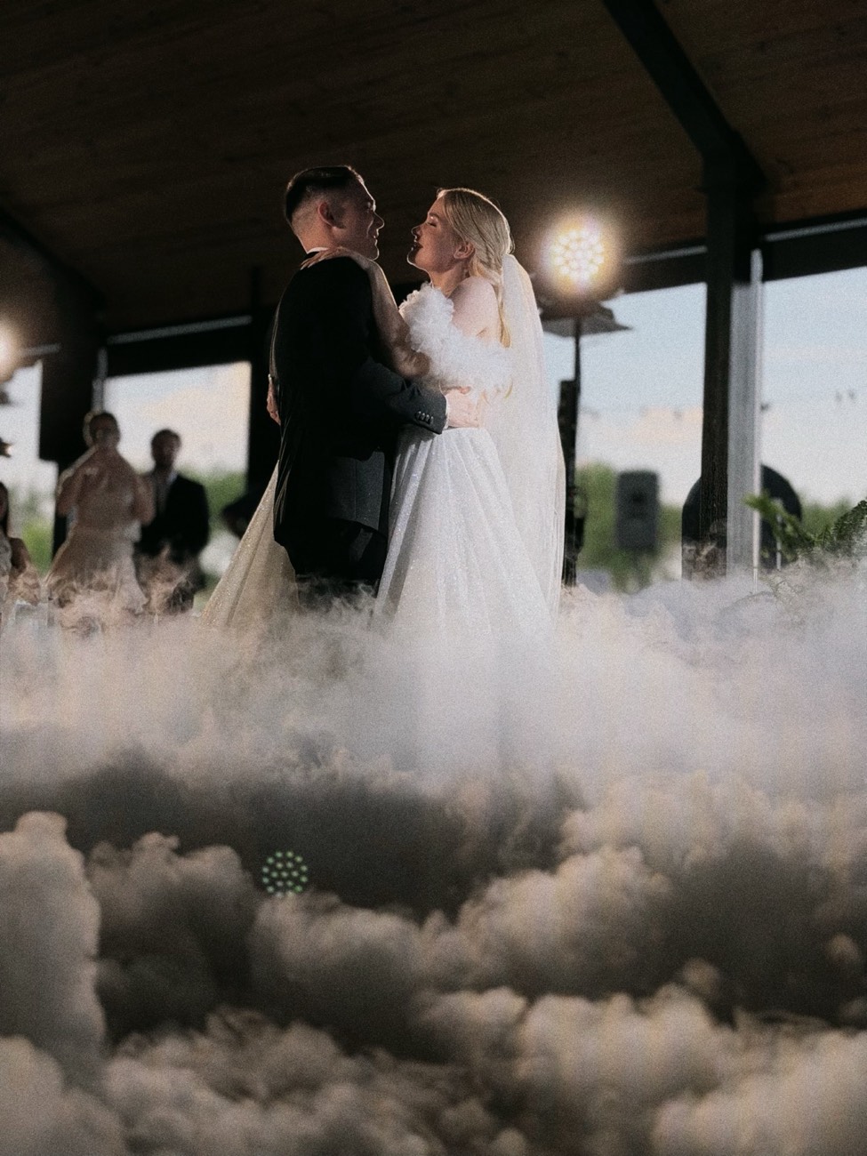 Couple embracing during the first dance surrounded by low fog — wedding at Casa Antonio (Alicante)