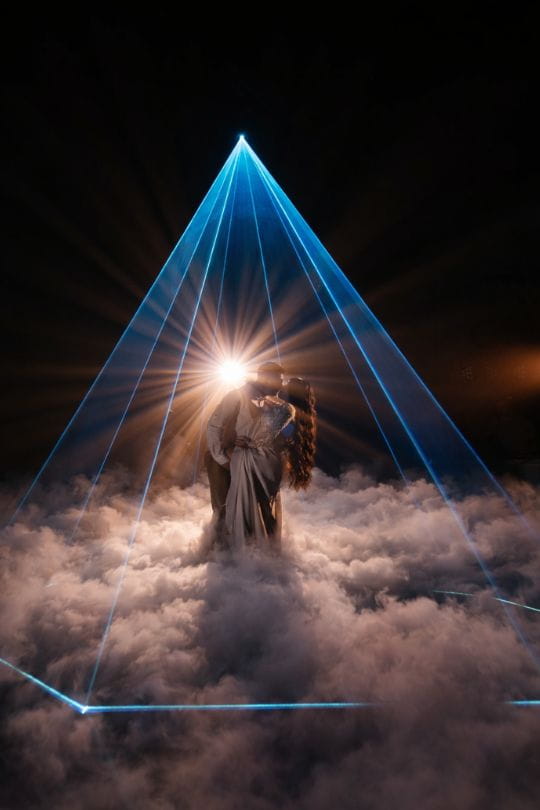 Novios bailando entre nubes de niebla
